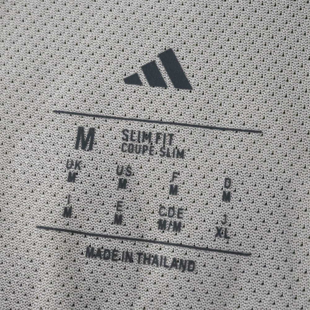 Close-up of the SL Benfica Away 2025/26 Player Version shirt's inner size and care label.