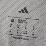 Close-up of the SL Benfica Away 2025/26 Player Version shirt's inner size and care label.