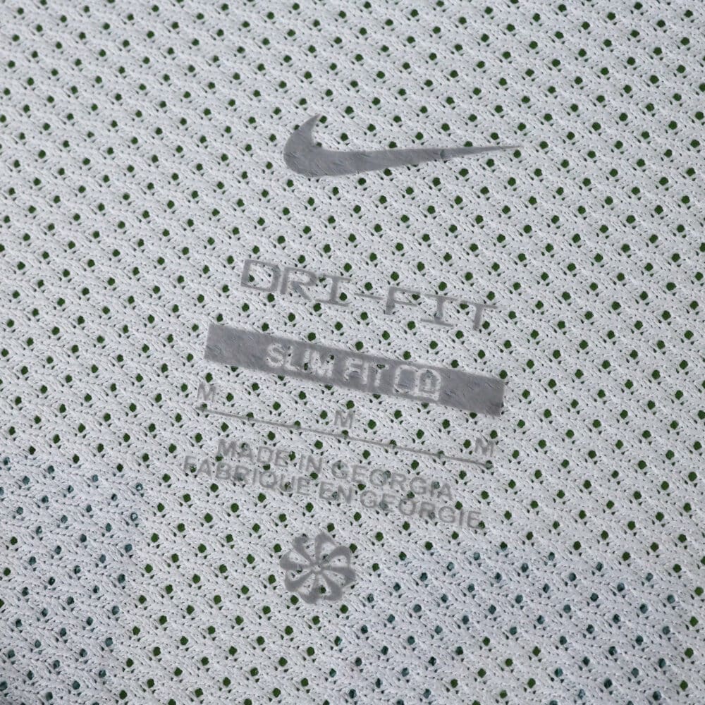 Close-up of Sporting CP Away 2025/26 Fan Version jersey fabric with Nike logo and Dri-FIT branding.