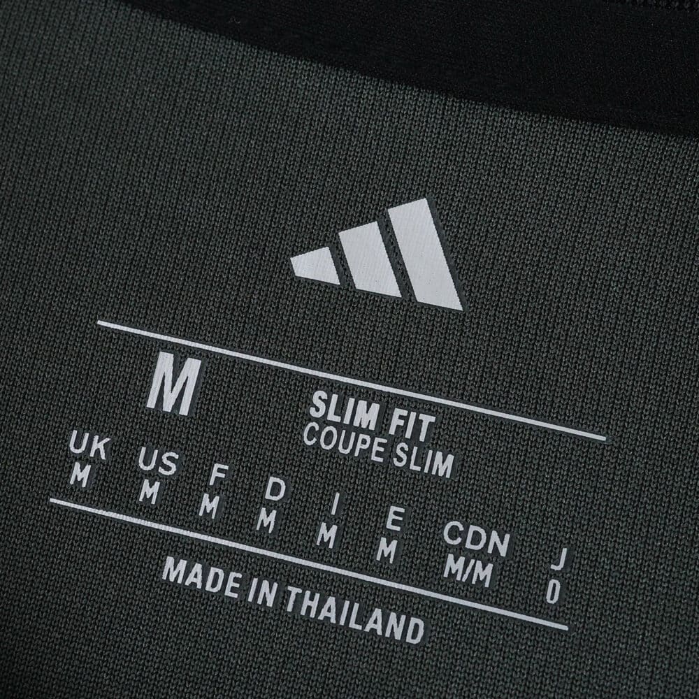 Close-up of Union Berlin Away 2025/26 Fan Version shirt label showing size M, slim fit, and Adidas logo.