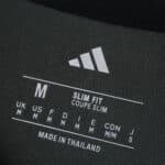 Close-up of Union Berlin Away 2025/26 Fan Version shirt label showing size M, slim fit, and Adidas logo.