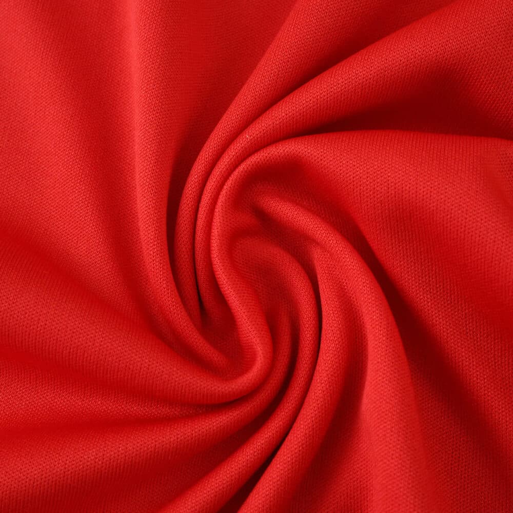 Close-up of red fabric from the Aberdeen Home 2025/26 fan version football shirt.