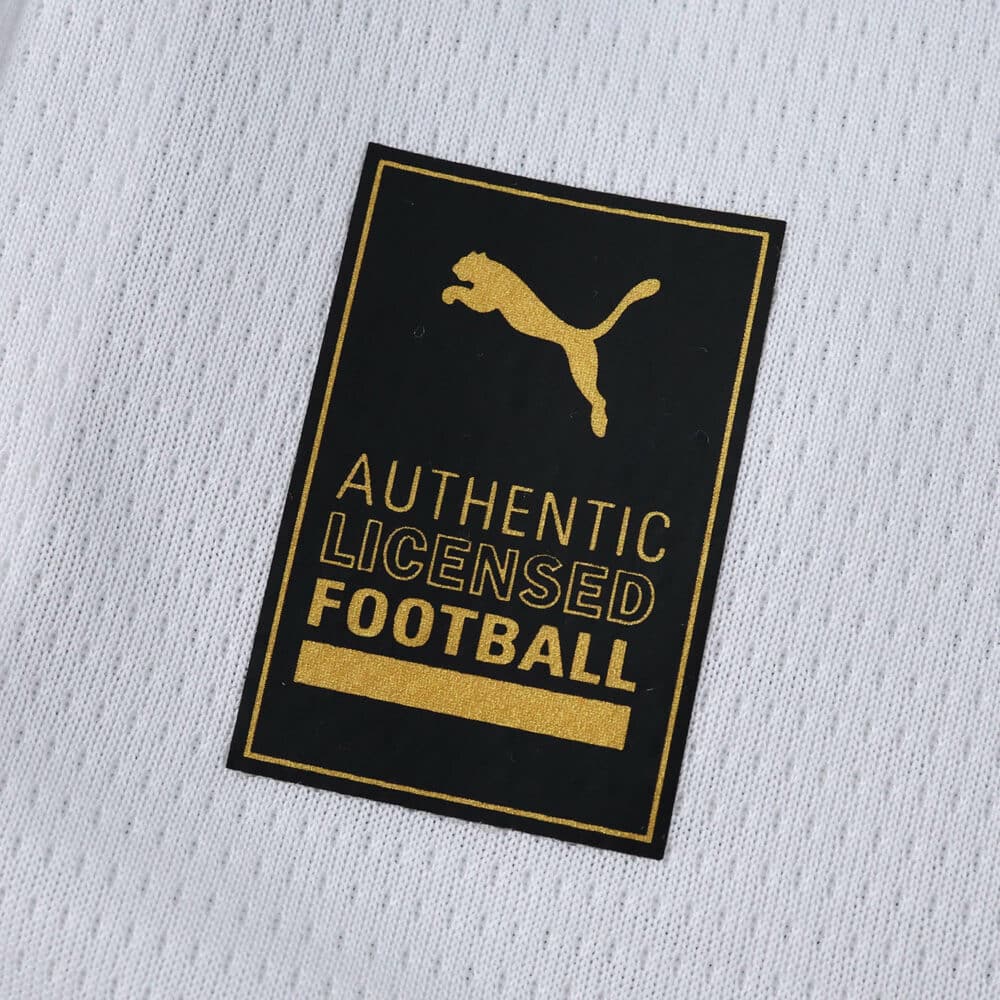 Close-up of the Puma Authentic Licensed Football badge on the AC Milan 2025/26 Away Fan Version jersey.