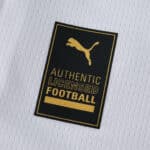 Close-up of the Puma Authentic Licensed Football badge on the AC Milan 2025/26 Away Fan Version jersey.