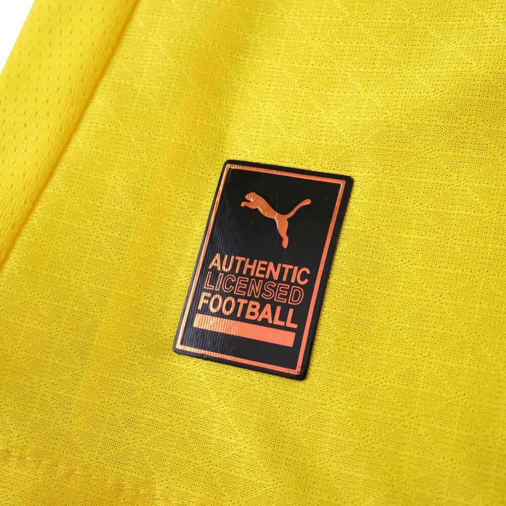 Close-up of the Borussia Dortmund 2025/26 Player Home Jersey showing Puma Authentic Licensed Football badge.