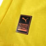 Close-up of the Borussia Dortmund 2025/26 Player Home Jersey showing Puma Authentic Licensed Football badge.