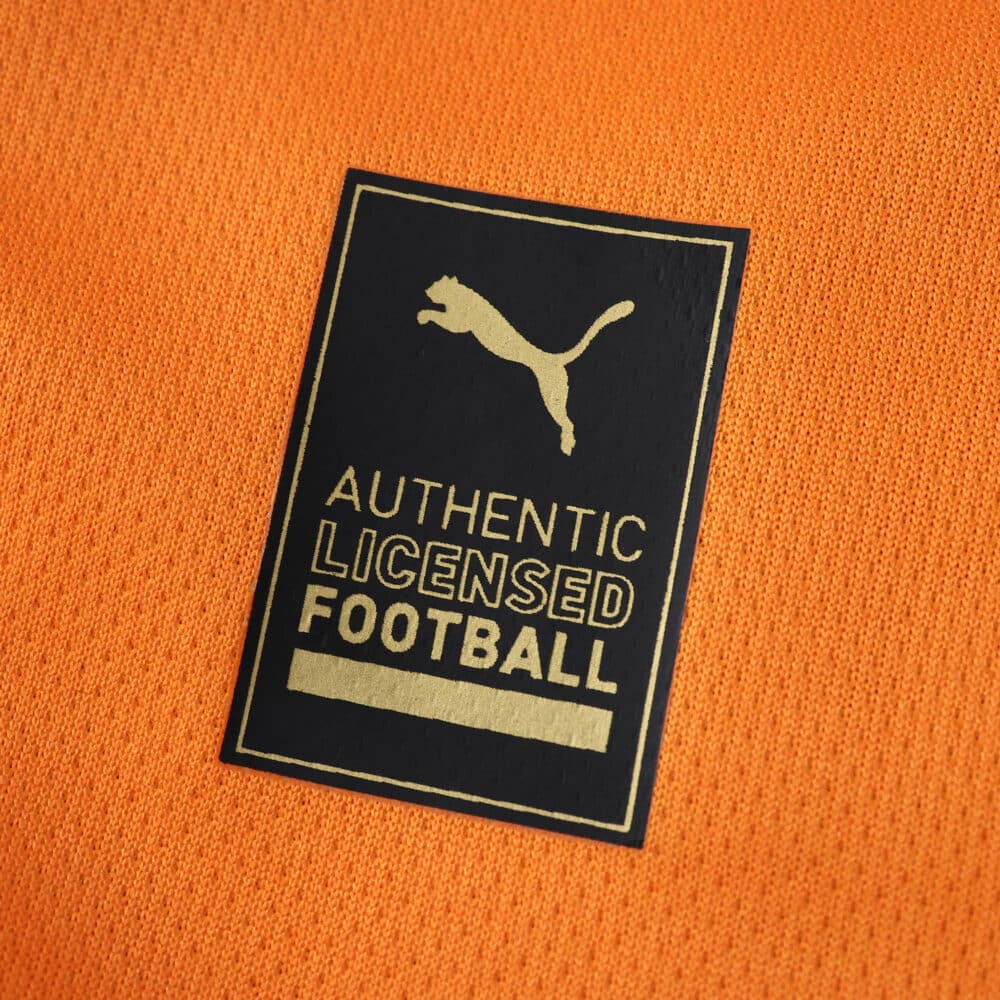 Close-up of a Puma "Authentic Licensed Football" patch on the Galatasaray Home 2025/26 Fan Version jersey.