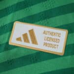Close-up of Adidas Authentic Licensed Product badge on the Newcastle United 2025/26 away player jersey.