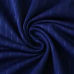 Close-up of Newcastle United Third 2025/26 Fan Version jersey fabric in deep blue with subtle textured pattern.