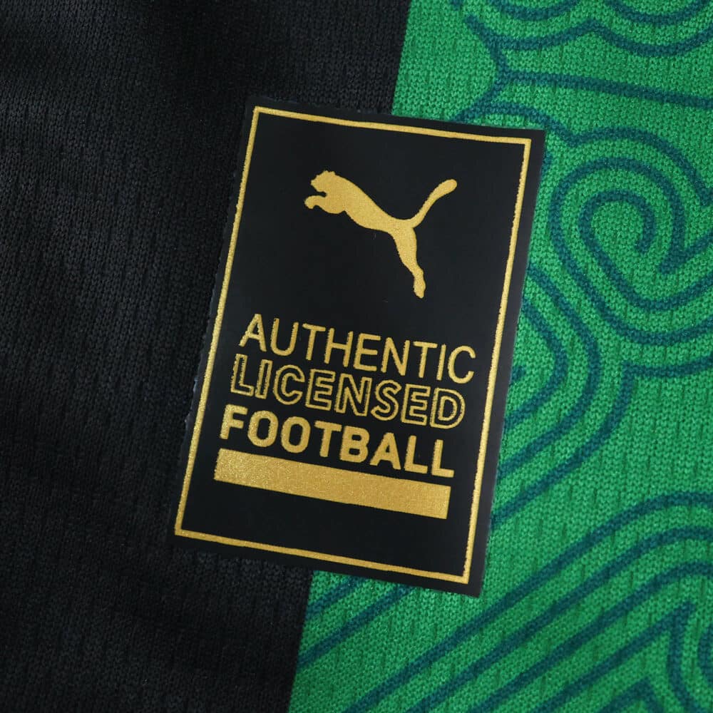 Close-up of the RC Lens Away 2025/26 Fan Version showing Puma authentic licensed football badge.