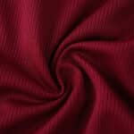 Close-up of the textured red fabric used in the Roma Home 2025/26 Fan Version jersey.