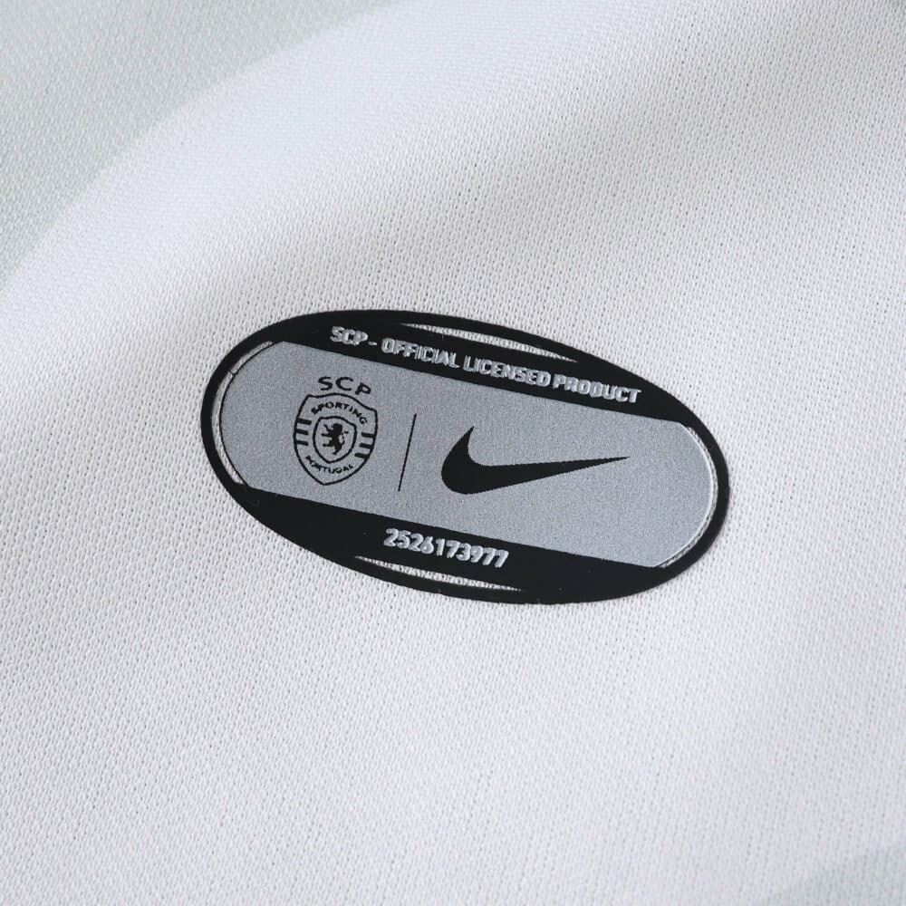 Close-up of the Sporting CP Away 2025/26 Fan jersey showing official license and Nike logo patch.