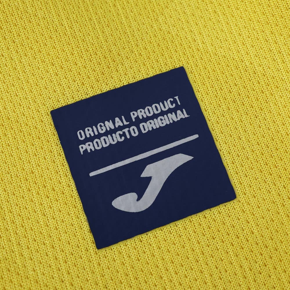 Joma original product label on the Villarreal 2025/26 home fan jersey yellow fabric.