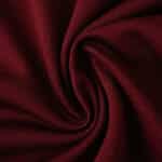 Close-up of West Ham United 2025/26 home fan jersey fabric in deep claret red, showing detailed texture.