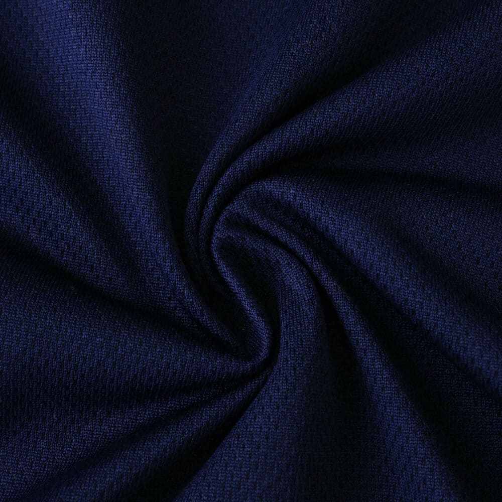 Close-up of navy blue fabric used in Ajax Away 2025/26 Player Version jersey, showing texture and weave.