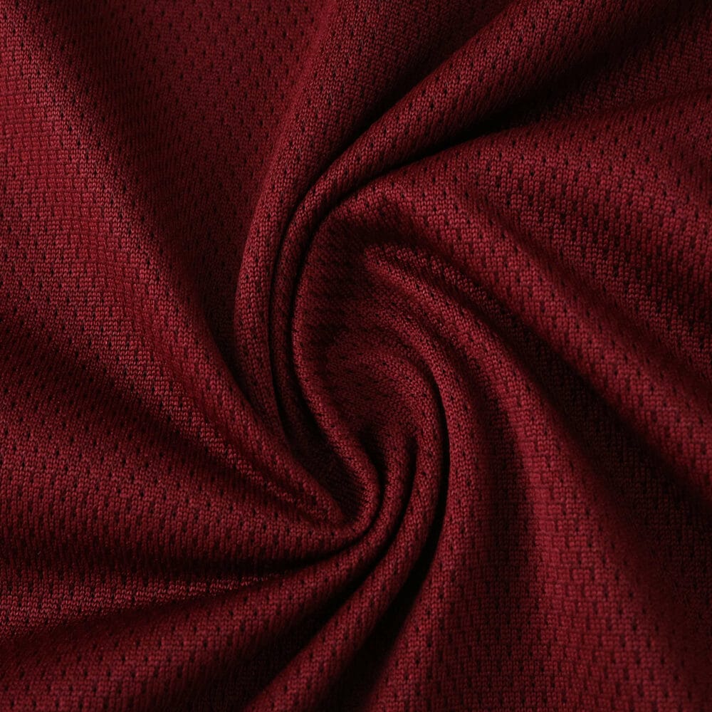Close-up of Aston Villa 2025/26 Home Player Version jersey fabric in deep claret red with textured pattern.