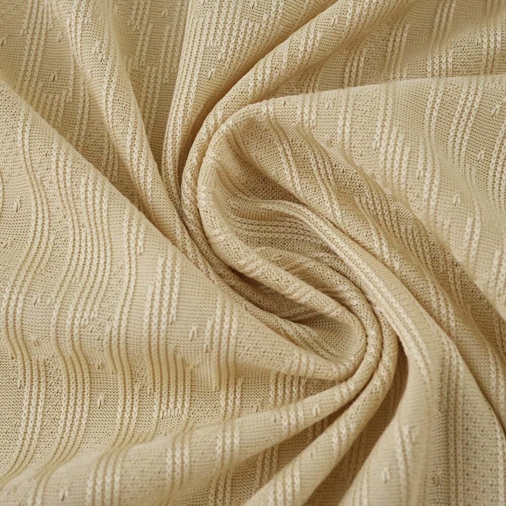 Close-up of the textured beige fabric used in the Barcelona Away 2025/26 Player Version jersey.