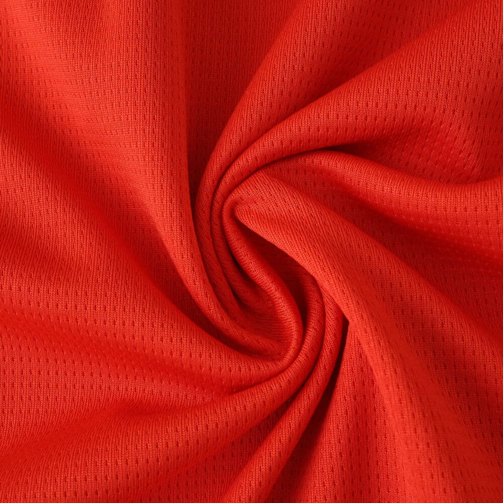 Close-up of red Braga Home 2025/26 fan version jersey fabric showing texture and material quality.