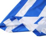 Close-up of the Brighton & Hove Albion 2025/26 home fan jersey fabric showing blue and white stripes.