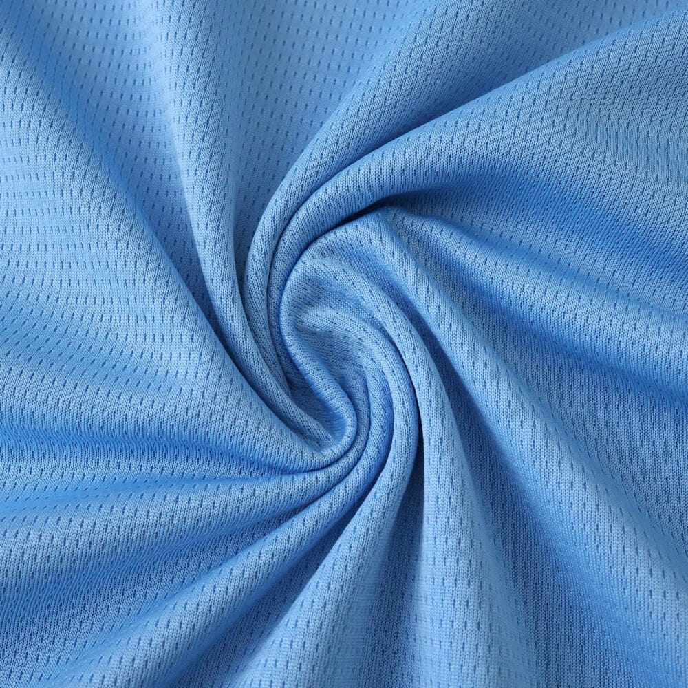 Close-up of light blue Feyenoord Away 2025/26 Fan Version fabric showing texture and weave.