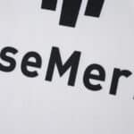 Close-up of the sponsor logo on the Hamburger SV Home 2025/26 Fan Version jersey, showing part of the text.