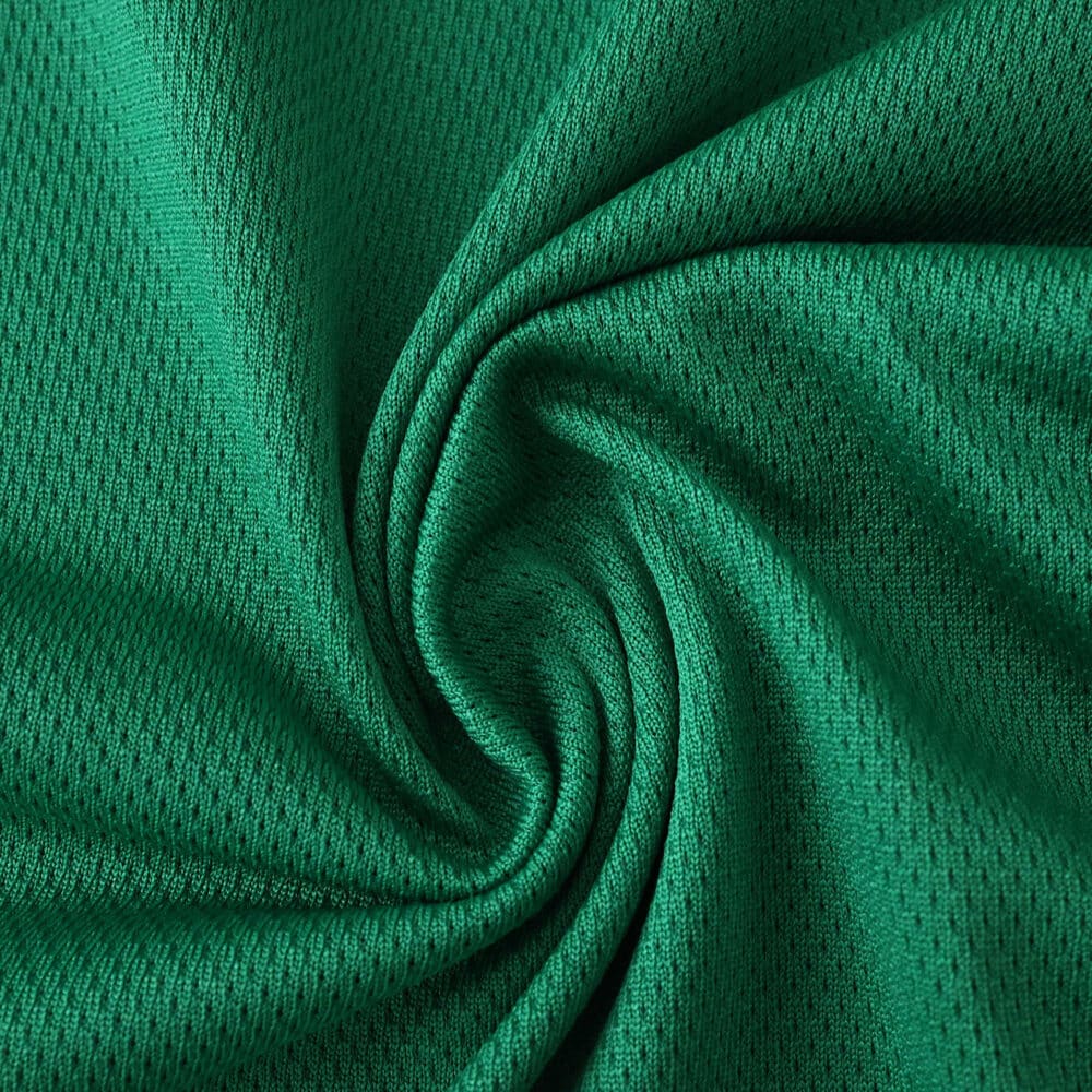 Close-up of green Newcastle United Away 2025/26 Player Version jersey fabric texture.