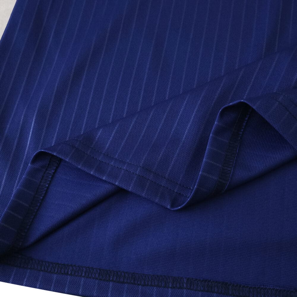 Close-up of the 2025/26 Newcastle United Third Fan Version shirt fabric in deep blue with subtle stripes.