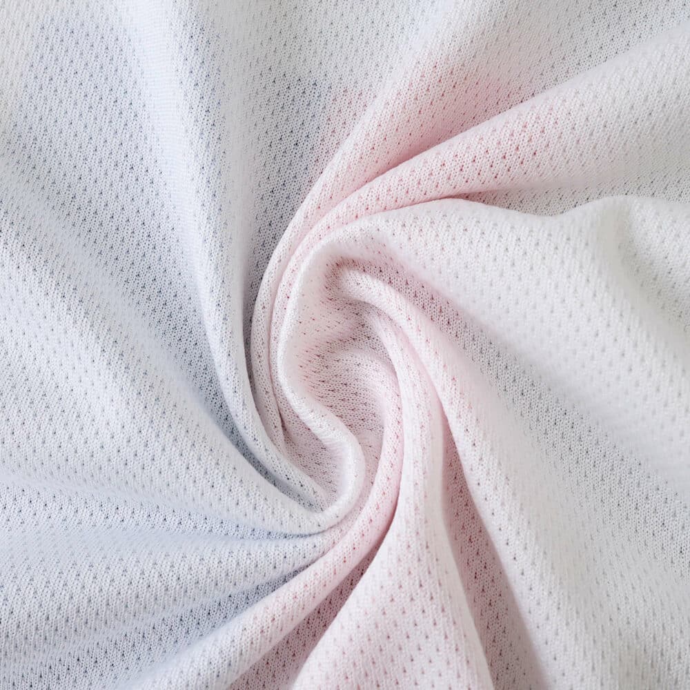 Close-up of Olympique Lyonnais 2025/26 Home Player Version jersey fabric texture in white.