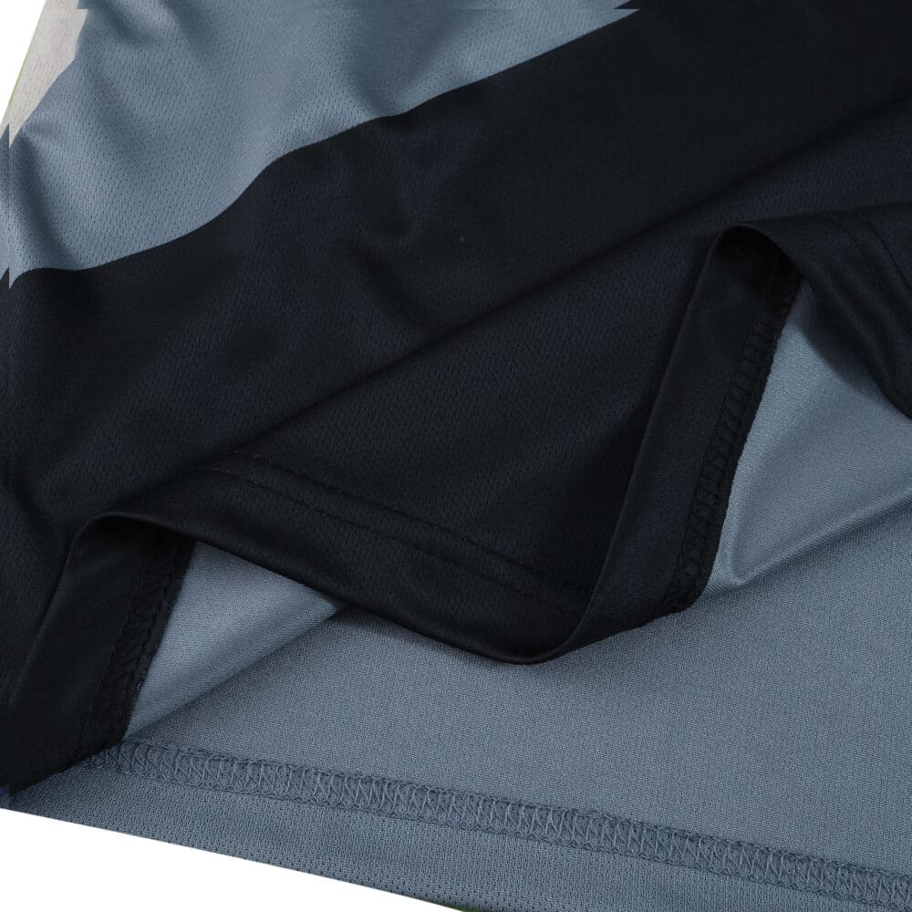 Close-up of Rangers Third 2025/26 Fan Version jersey fabric in black and silver colors.