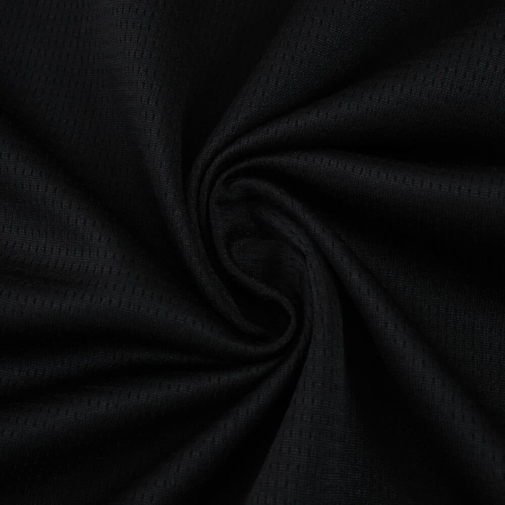 Close-up of the dark fabric used in the RC Lens Away 2025/26 Fan Version jersey, showing texture and detail.