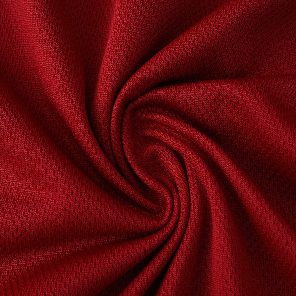 Close-up of red Roma Home 2025/26 Player Version jersey fabric showing texture and quality.