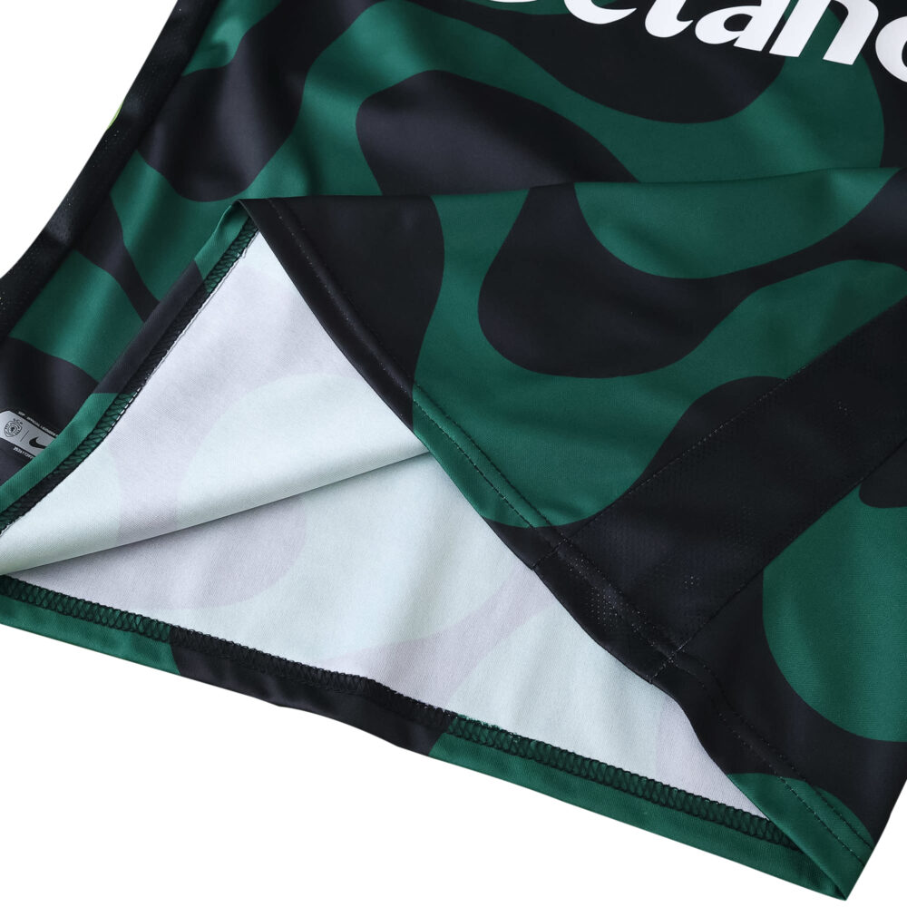 Close-up of Sporting CP Third 2025/26 Fan Version jersey fabric with green and black pattern.