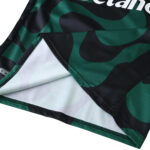 Close-up of Sporting CP Third 2025/26 Fan Version jersey fabric with green and black pattern.