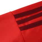 Close-up of the red Aberdeen 2025/26 home fan jersey showing maroon stripe details on the shoulder.