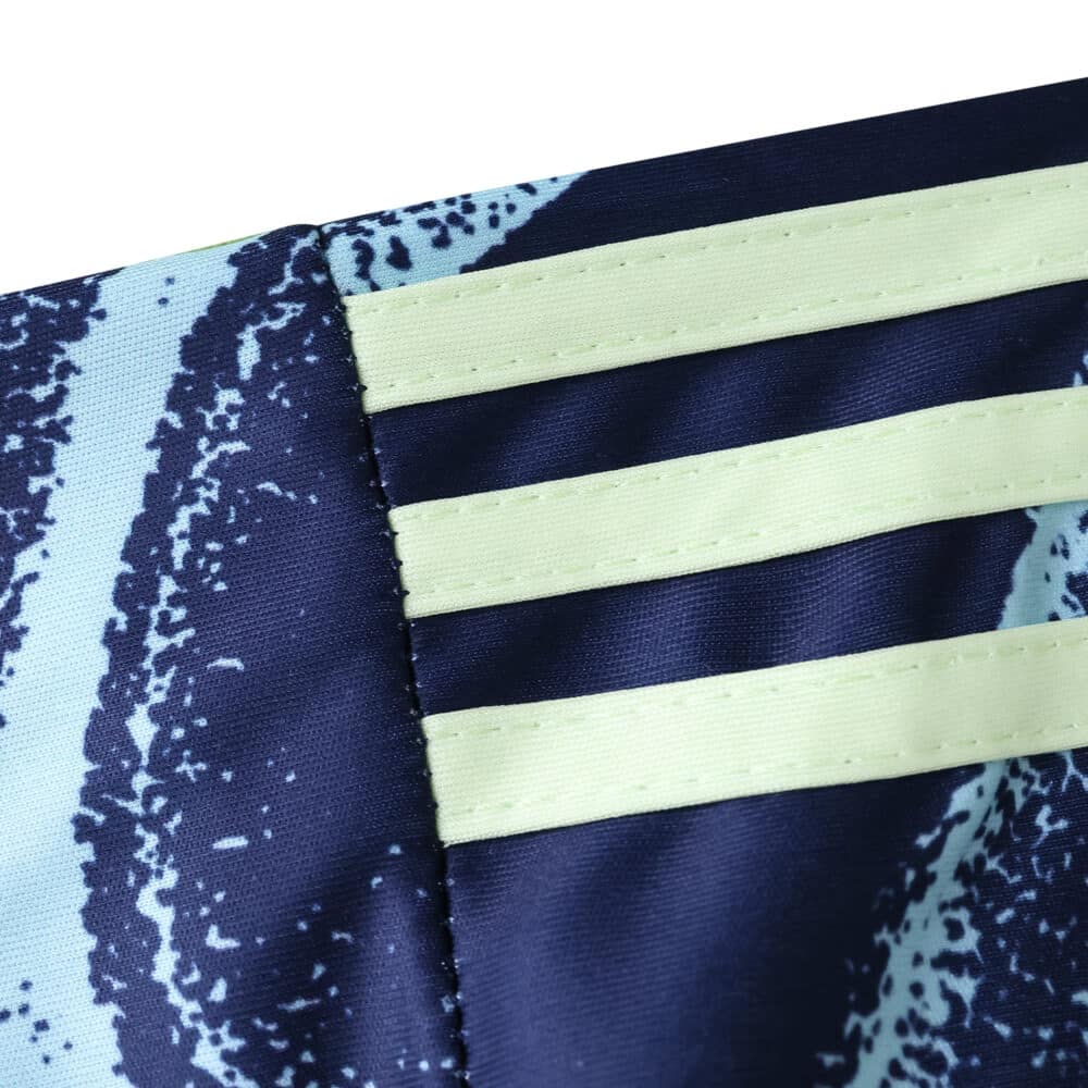 Close-up of the Ajax Away 2025/26 Fan Version jersey, showing light yellow stripes on a navy background.