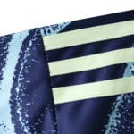 Close-up of the Ajax Away 2025/26 Fan Version jersey, showing light yellow stripes on a navy background.