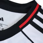 Close-up of Fulham Home 2025/26 Fan Version jersey collar with black and red stripe detail.