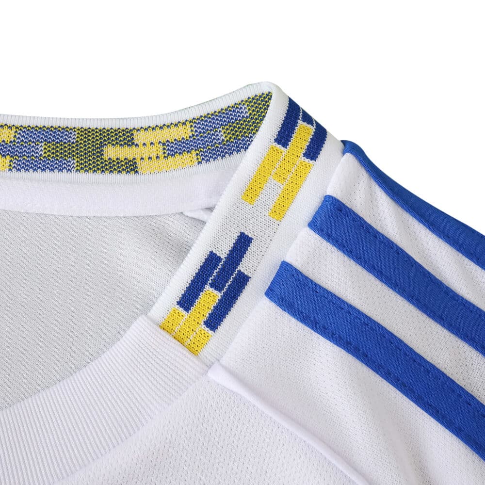 Close-up of Leeds United Home 2025/26 Fan Version jersey collar with blue and yellow trim detail.