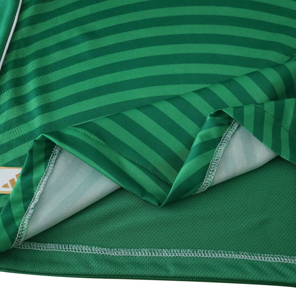 Close-up of Newcastle United Away 2025/26 Player Version jersey showing green stripes and fabric details.