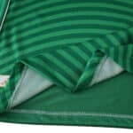 Close-up of Newcastle United Away 2025/26 Player Version jersey showing green stripes and fabric details.