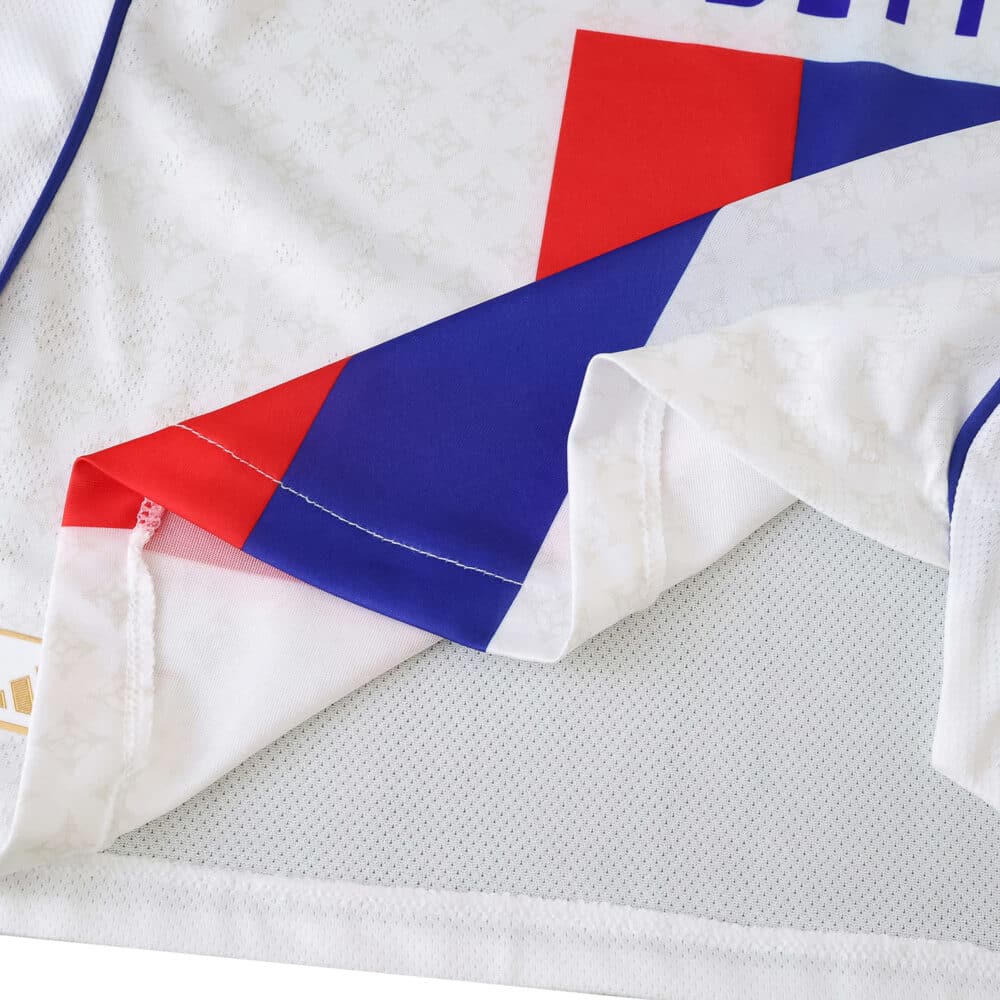 Close-up of Olympique Lyonnais 2025/26 Home Player Version jersey, showing fabric detail and red-blue graphic.