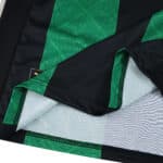 Close-up of the RC Lens Away 2025/26 Fan Version jersey, showing green pattern and texture details.