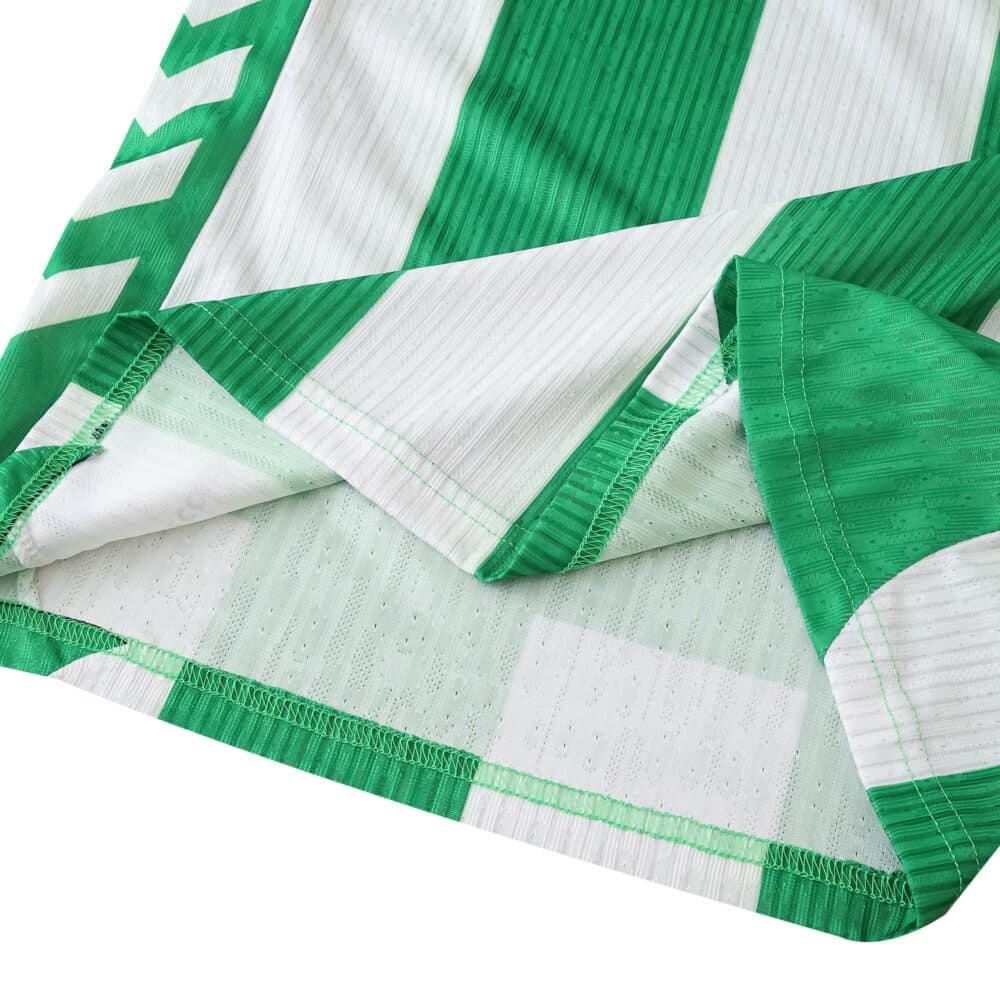 Close-up of Real Betis 2025/26 home player jersey fabric showing green and white stripes and stitching.