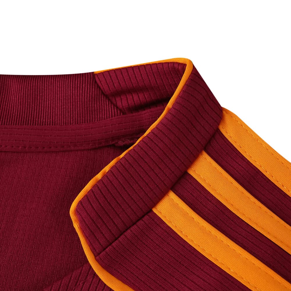 Close-up of the Roma 2025/26 fan jersey collar, showing red fabric with yellow trim and stripes.