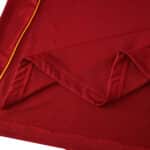 Close-up of the Roma 2025/26 Home Player Version jersey fabric in deep red with gold trim detail.
