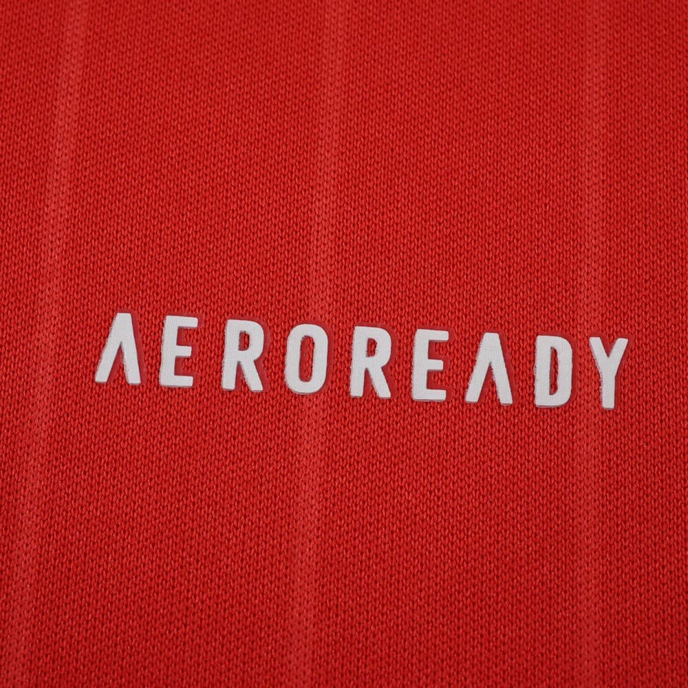 Close-up of the red 2025/26 Aberdeen Home Fan Version jersey fabric with "AEROREADY" logo.