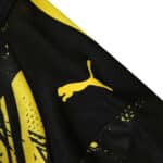 Close-up of Borussia Dortmund 2025/26 Home Player Version jersey featuring yellow Puma logo on the shoulder.