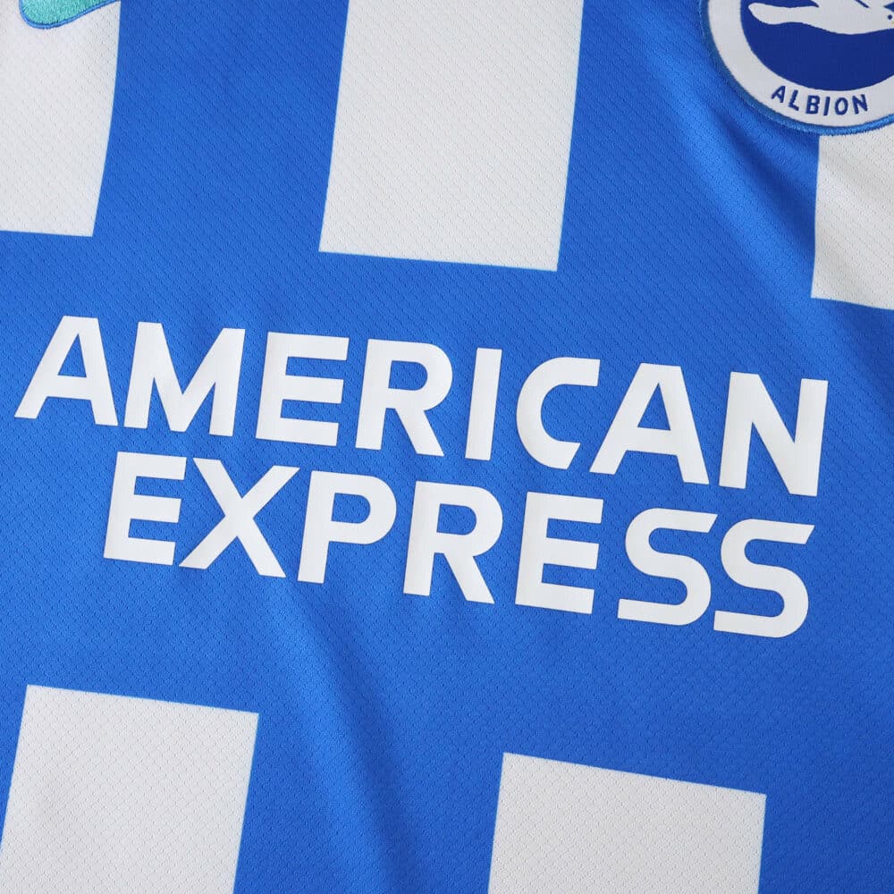 Close-up of Brighton & Hove Albion 2025/26 Home Fan jersey featuring American Express sponsor logo.