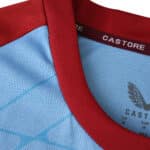 Close-up of Feyenoord 2025/26 Away Fan Jersey collar with red trim and Castore branding.