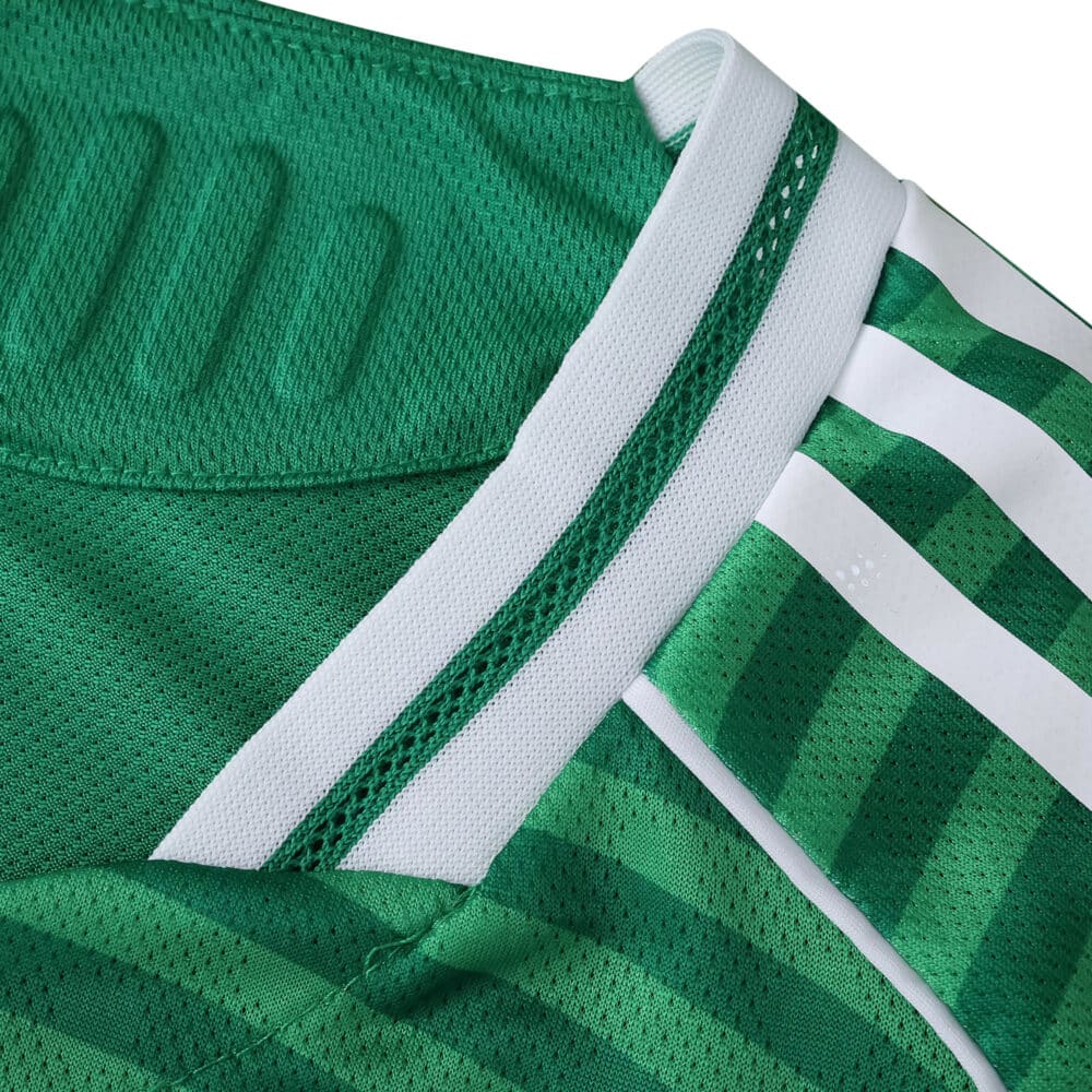 Close-up of Newcastle United Away 2025/26 Player Version jersey showing green fabric and white stripes.